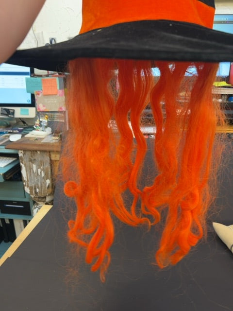Black and orange witch hat with orange wig hair attached