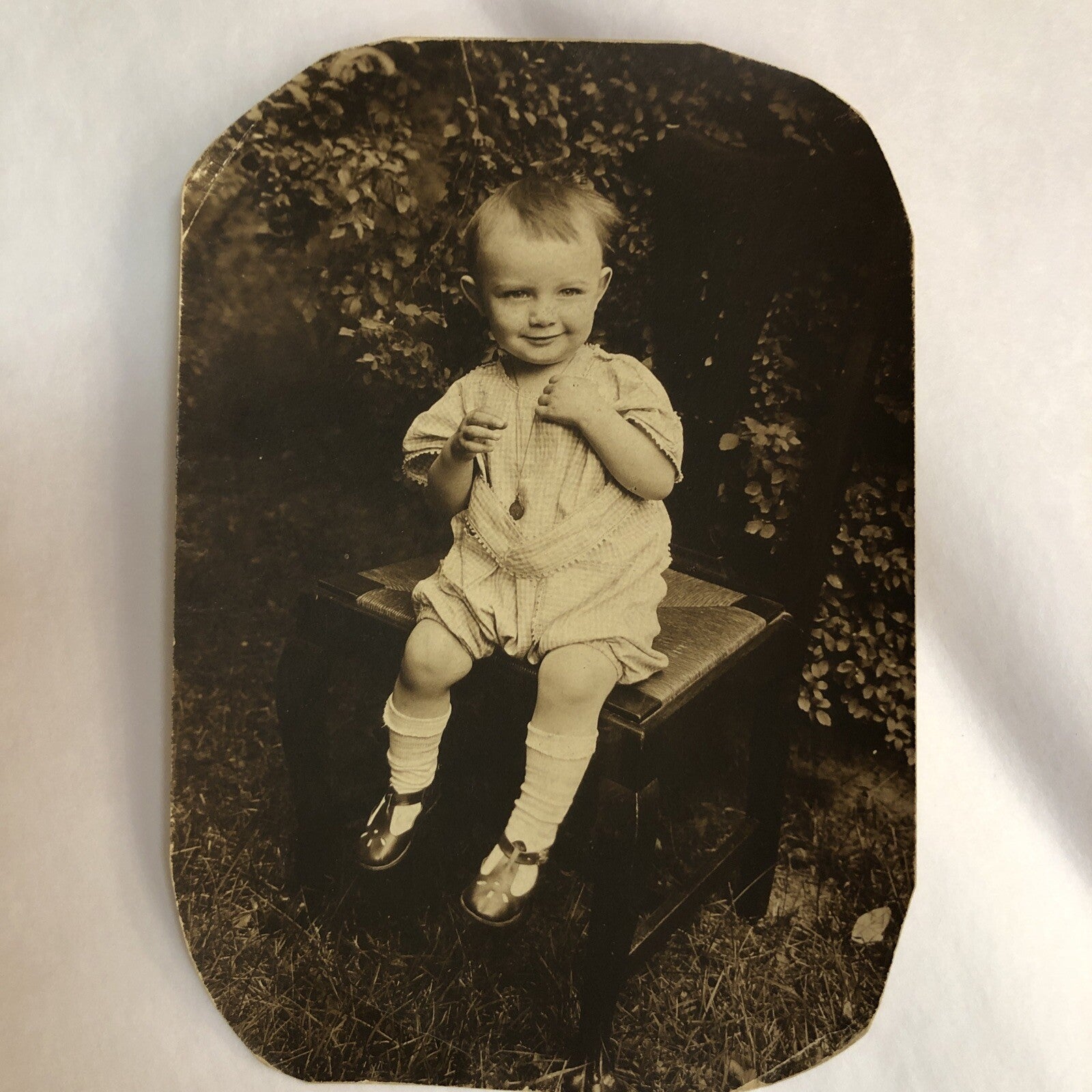 Real Photo 3-1/4x4-3/4"  Toddler Baby Wears Necklace Sitting on Caned Chair