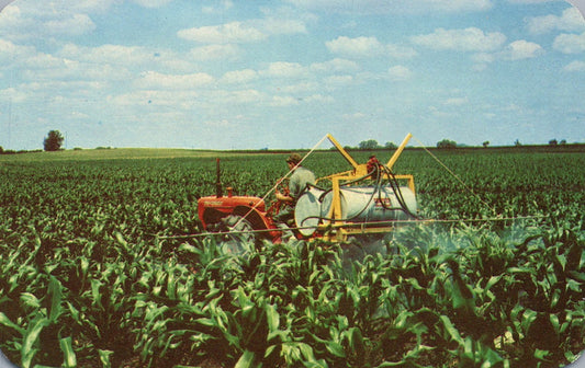 Watering corn in a field on a tractor Vintage postcard