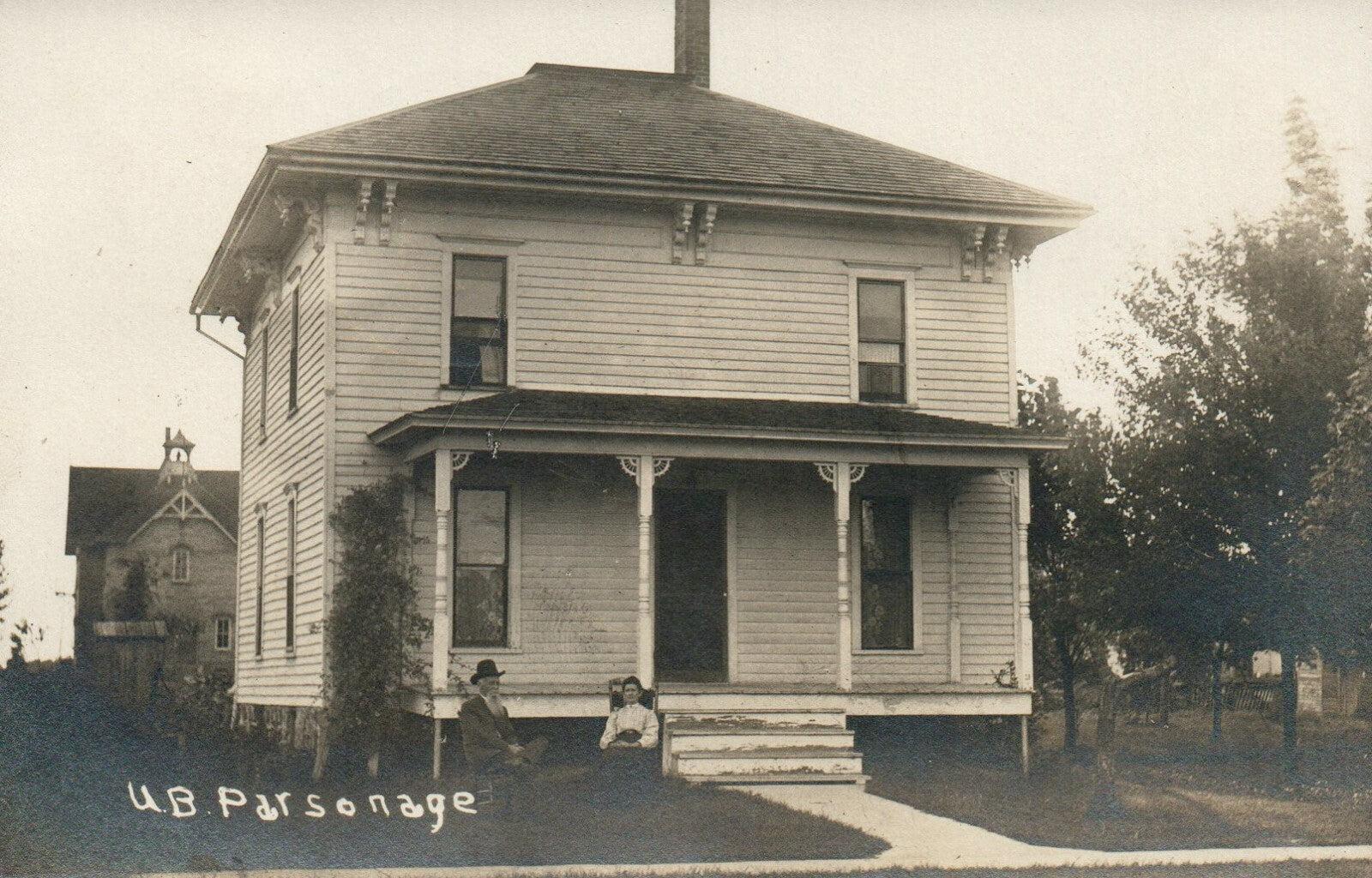 UB Parsonage Man and Woman Sitting Outside House Sunfield Michigan MI Postcard