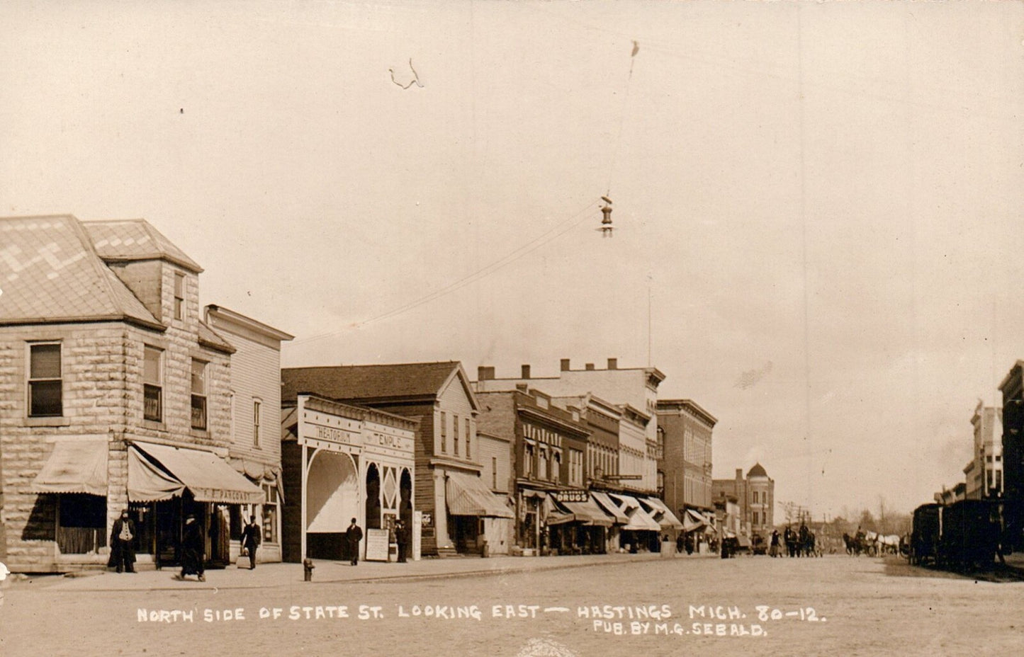 Real Photo North Side of State St. Looking East in Hastings Michigan MI Postcard