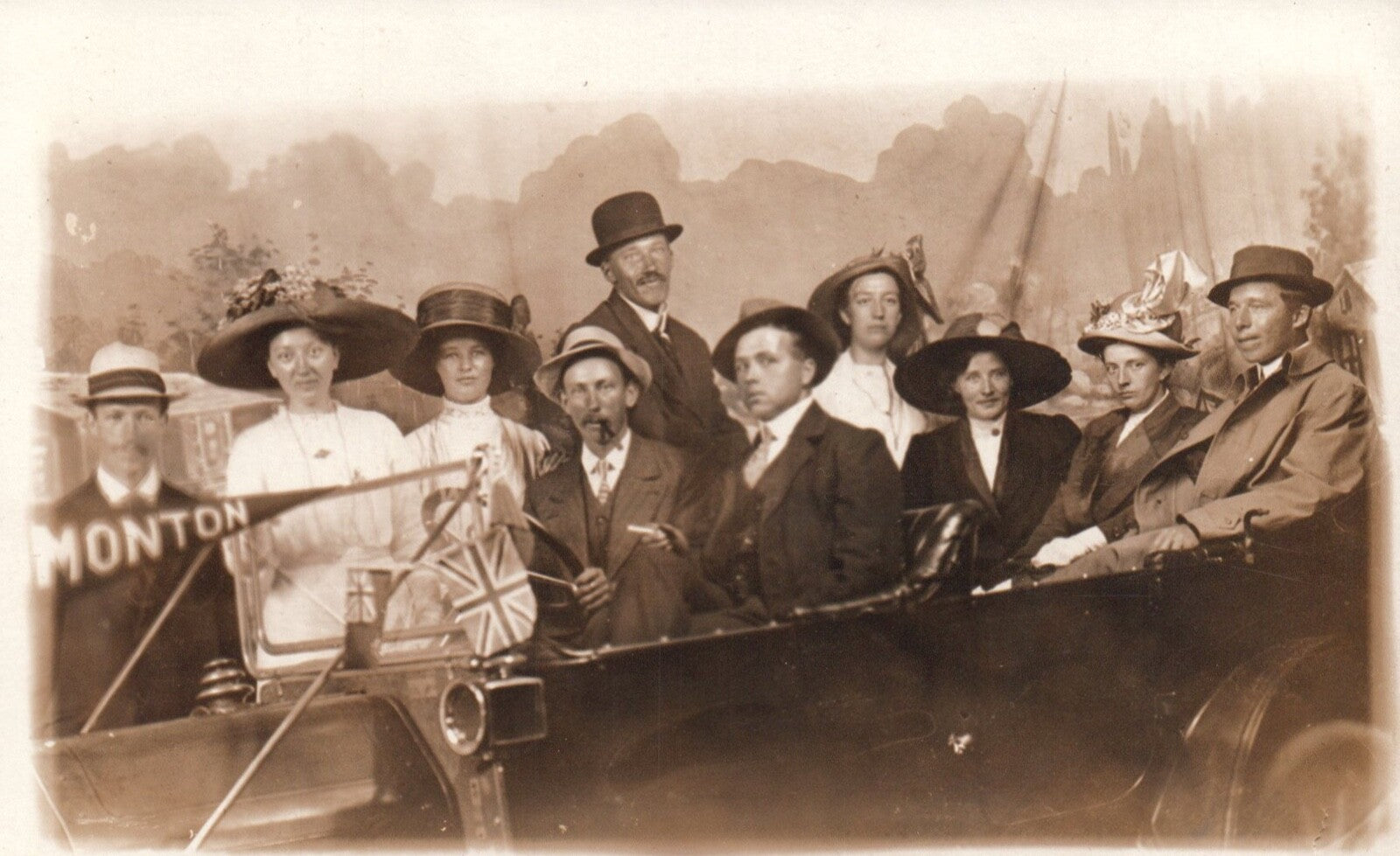 Real Photo Studio Photo of People In Car Holding Flag Monton England UK Postcard