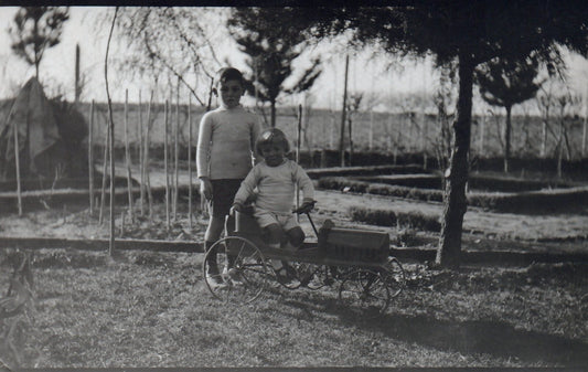 Real Photo Two Young Children Playing with an Old Toy Pedal Car Postcard
