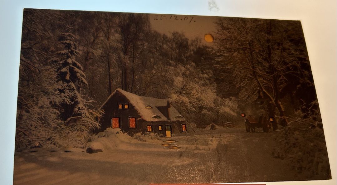 Cabin in woods Covered in snow with wagon