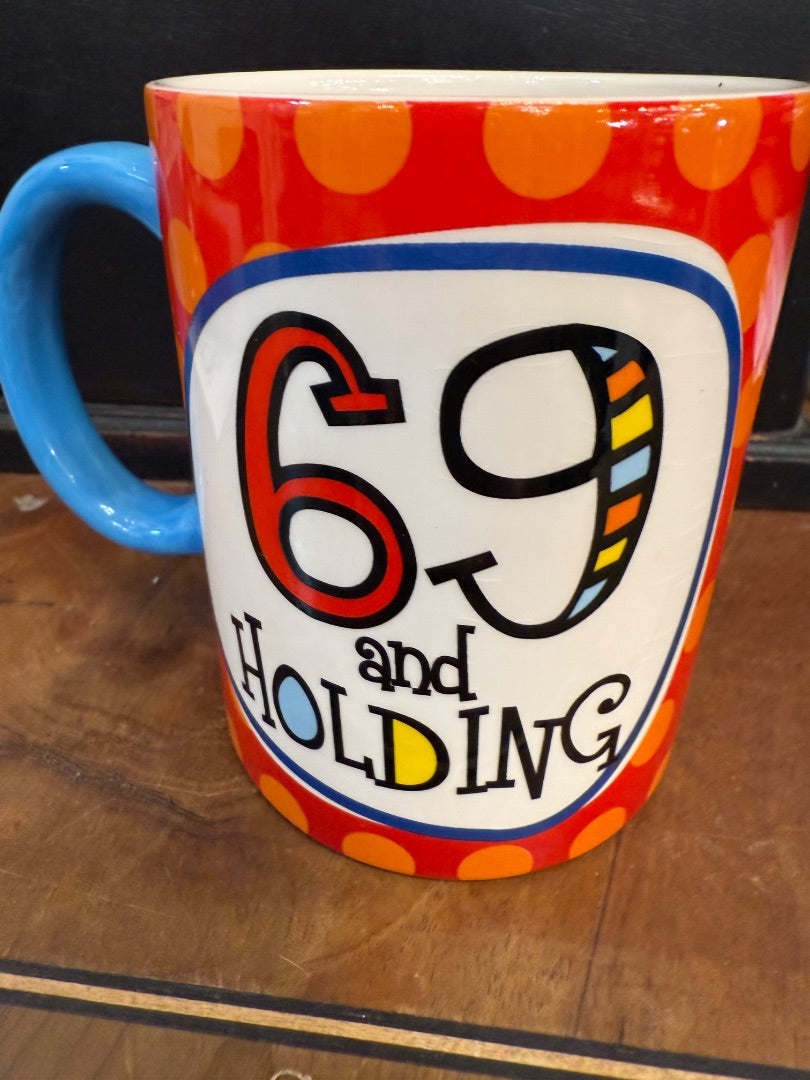 Coffee Cup 69 and Holding