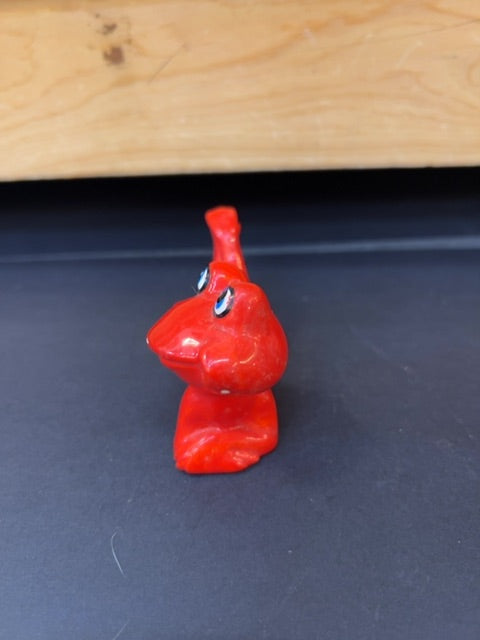 Posing red frog smiling