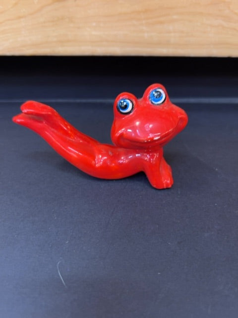Posing red frog smiling