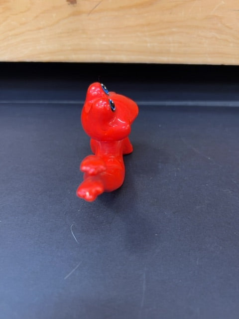 Posing red frog smiling